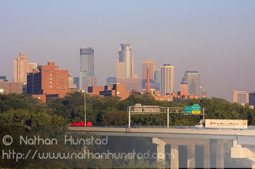 Downtown Minneapolis during rush hour from the Franklin Avenue Bridge. The Interstate 94 bridge across the river can be seen.